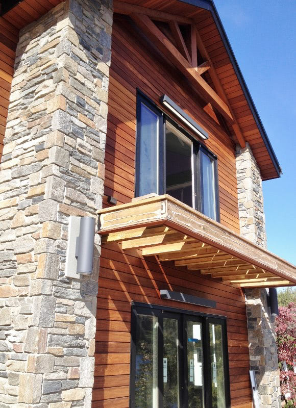 Ipe rain screen siding with stone accents on an exterior entryway