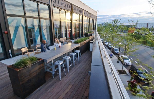 Cozy hardwood rooftop deck and seating at sunset