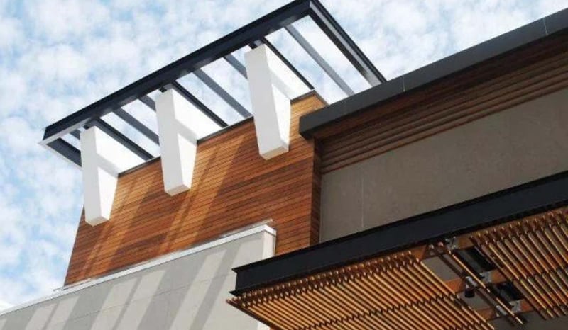 Detail of an exterior with Ipe wood rainscreen siding and pergola screen in Florida