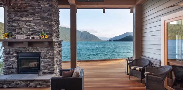 A luxurious outdoor fireplace and lakeside deck made from high quality fire retardant treated decking material from Mataverde Decking.
