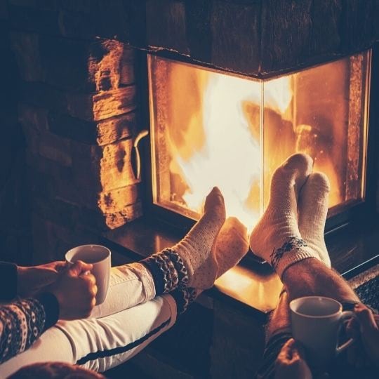 Fireplace socked feet and cocoa