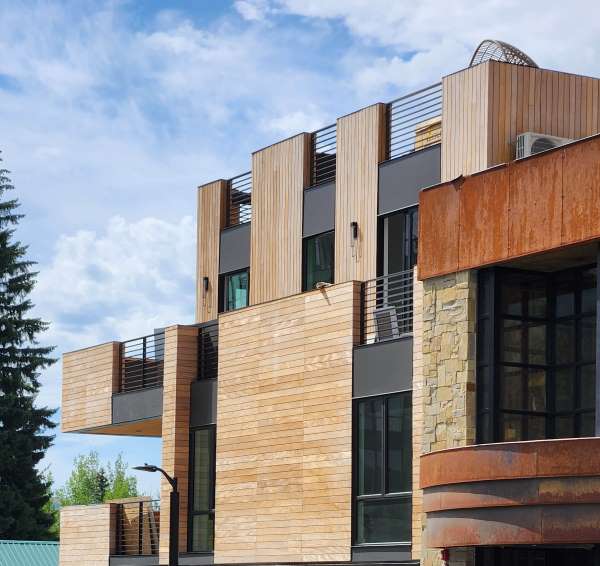Garapa Rainscreen contrast with stone, rusted metal, Vertical siding Sun Valley, ID, commercial and residential custom facade 45KB