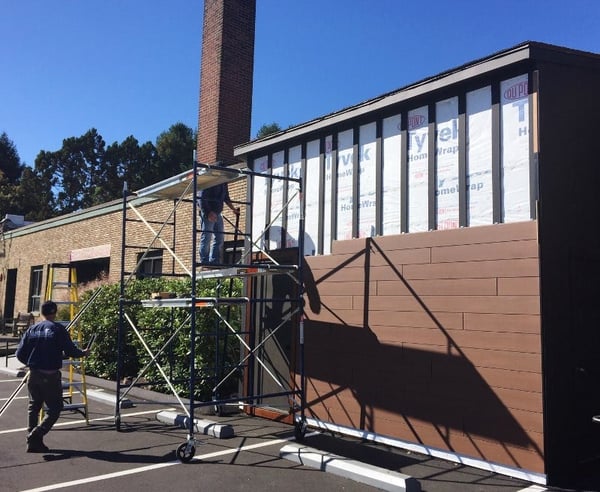 Installing Trespa Pura Tropical Ipe wood decor siding on building