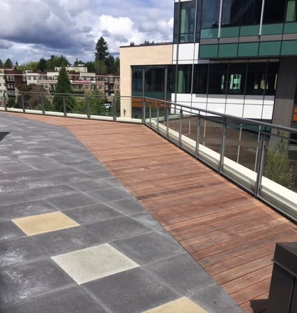 Integrated rooftop deck with full length hardwood boards and pavers