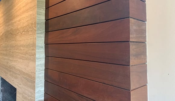 Interior wall paneling at fireplace features Ipe siding and outside corners to match the exterior