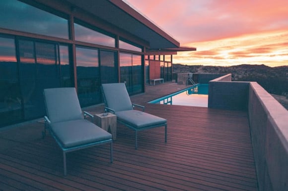 Ipe hardwood deck - photo courtesy of Roberto Nickson - lounge deck chairs next to infinity pool at sunset overlooking the landscape