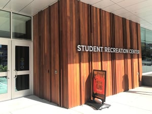 Ipe vertical rainscreen siding and fins at UConn Rec Center street side entrance