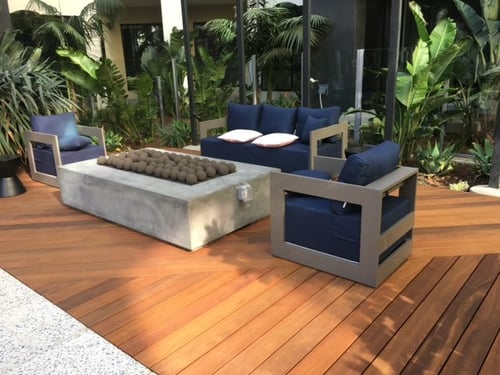 Rooftop deck space with natural hardwood decking in alternating diagonal layout