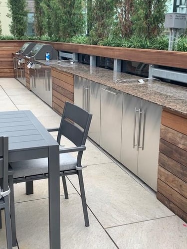 Ipe siding railings and planters on rooftop deck outdoor kitchen