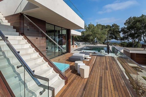Machiche hardwood deck poolside with stairs and stucco accents