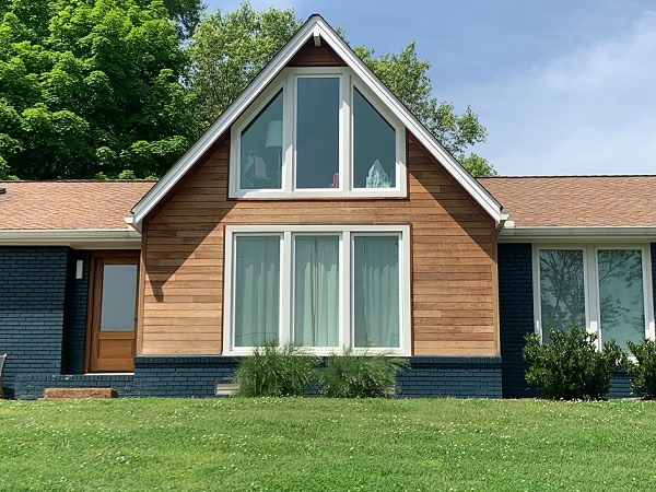 FSC Machiche wood rainscreen siding complements a painted brick façade to update a mid-century ranch home exterior