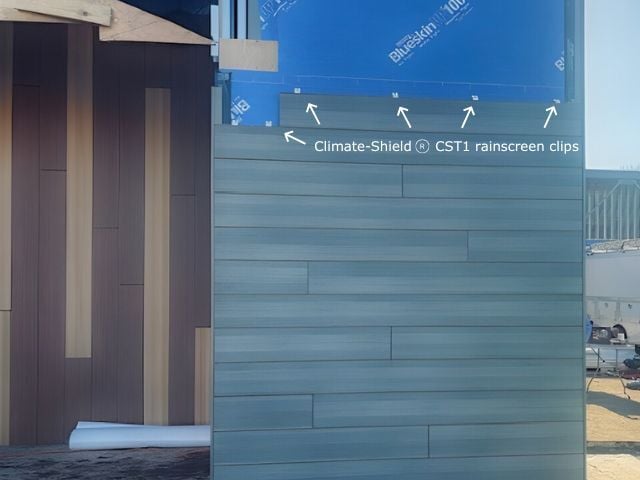 Matunuck Atelier under construction with arrows to clips Pura NFC Siding by Trespa Mystic Cedar horizontal siding using Climate-Shield CST1 Rainscreen System from MataverdeDecking.com