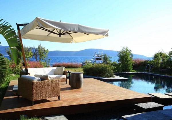 A luxurious poolside deck made from Mataverde Novathermowood thermally modified wood decking material.