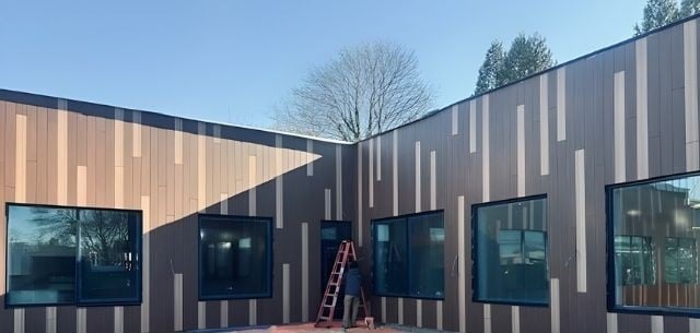 Matunuck Atelier under construction showing of Pura NFC Siding by Trespa Tropical Ipe and Western Red Cedar wood decors mixed color vertical siding using Climate-Shield CST1 Rainscreen System
