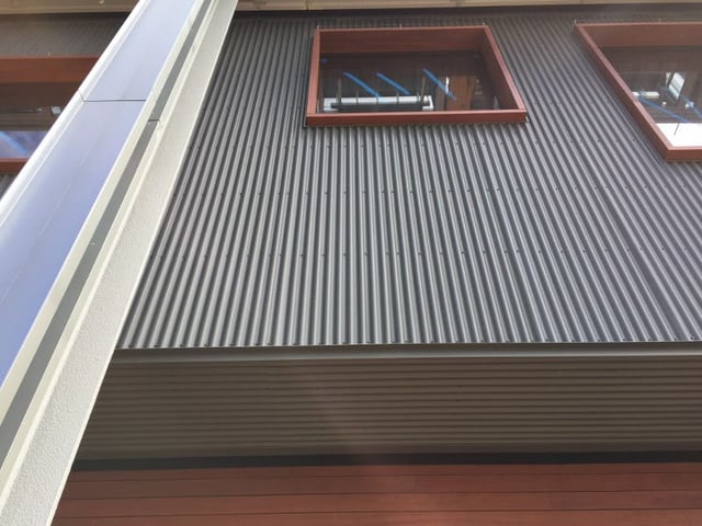 Metal siding with Jatoba hardwood rain screen siding below and Jatoba window trim.jpg