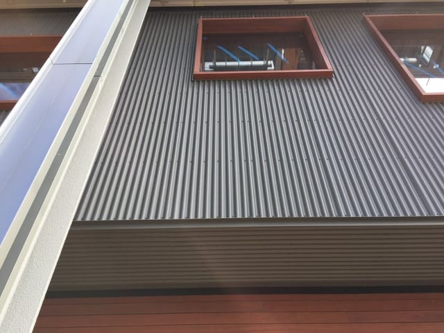 Metal siding with Jatoba hardwood rain screen siding below and Jatoba window trim.jpg