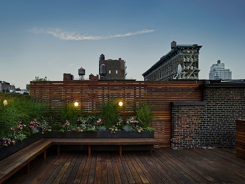 Ipe hardwood decking planters and screen with brick above New York City