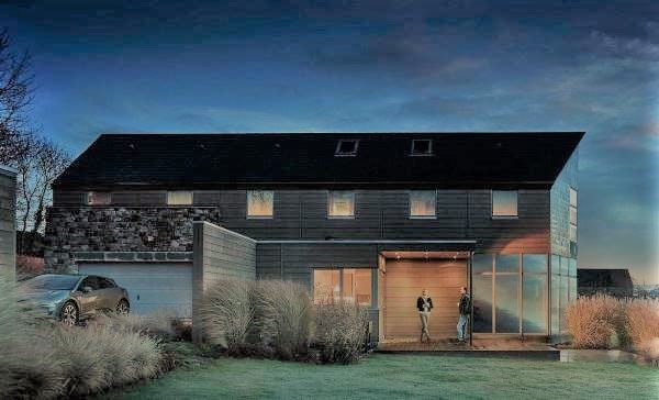 Black Siding - A barn-inspired home with Trespa Pura NFC siding in Slate Ebony and Classic Oak with stone