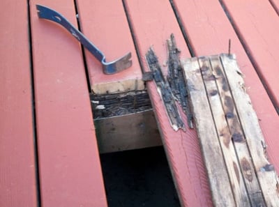 Redwood deck with rotted plank pulled out (stock photo)