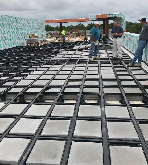 Rooftop deck frame with concrete ballast is expansive