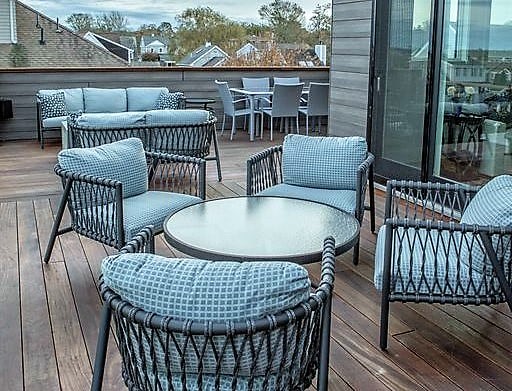 A raised 2nd floor balcony deck with dining and seating