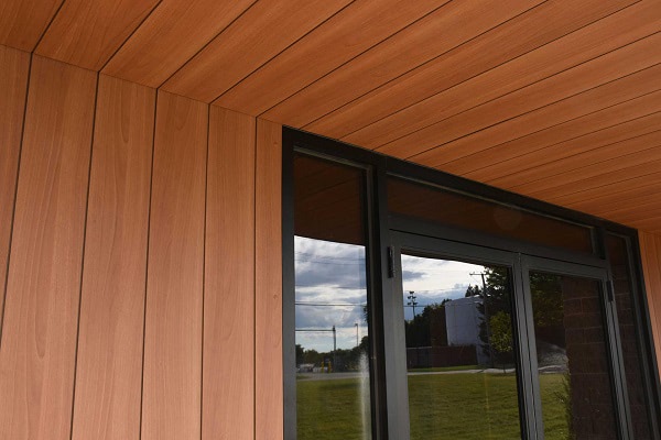 Trespa Pura NFC siding Romantic Walnut wood decor on entry siding and soffits