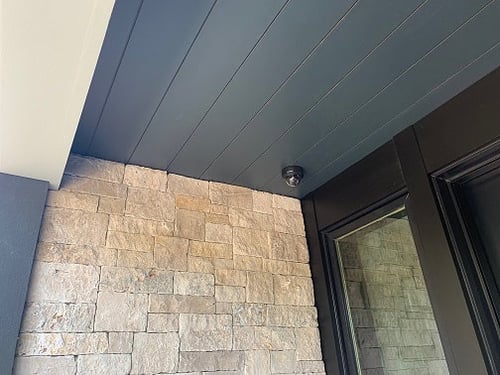 Trespa Pura siding Anthracite Gray P25.8.1 on soffits at entryway closeup