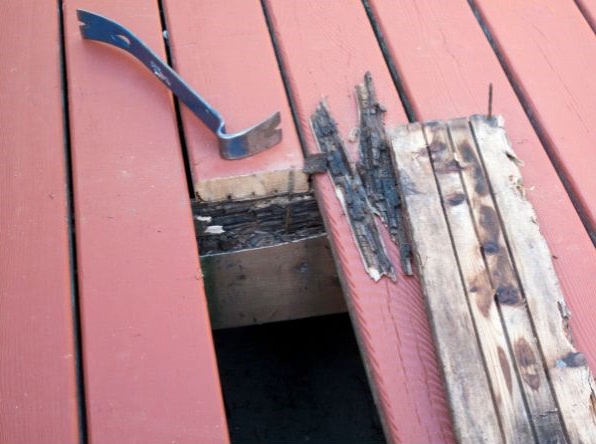 Redwood deck with rotted plank pulled out
