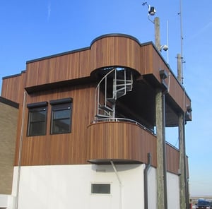 Vertical_ipe_rain_screen_siding_around_bartizan_at_USCG_station_in_Delaware