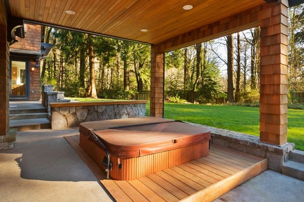 A hot tub in a wood pavilion creates a spa feel underfoot and above