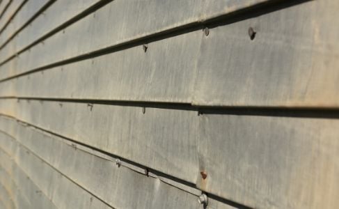 aged metal siding with nails stock photo