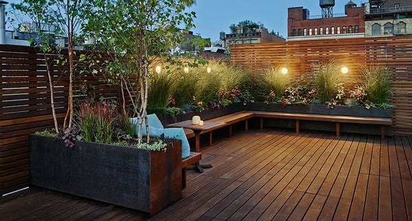 deck garden rooftop with all ahrdwood decking, seating, planters and privacy wall