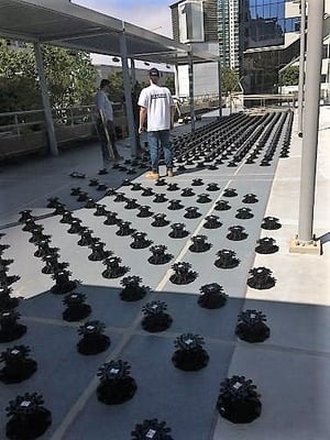 Eurotec rooftop deck pedestals from Mataverde during a rooftop deck installation