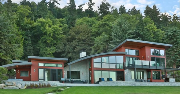 A modern home with curved roof lines and large windows with Pura NFC Romantic Walnut Wood Decor