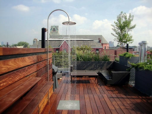 Mataverde Ipe wood rooftop deck with built in bench and shelves with poolside shower