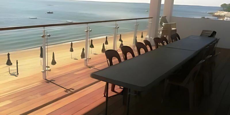 wood rooftop deck dining area overlooking the beach