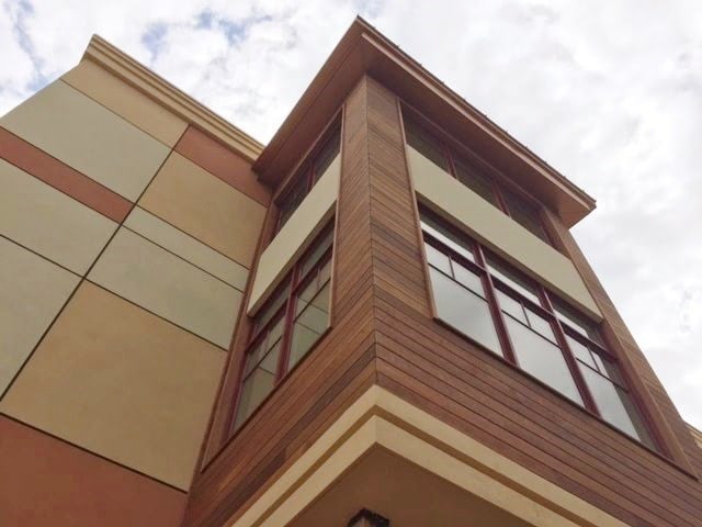 Natural wood siding combined with stucco on a commercial rainscreen wood project